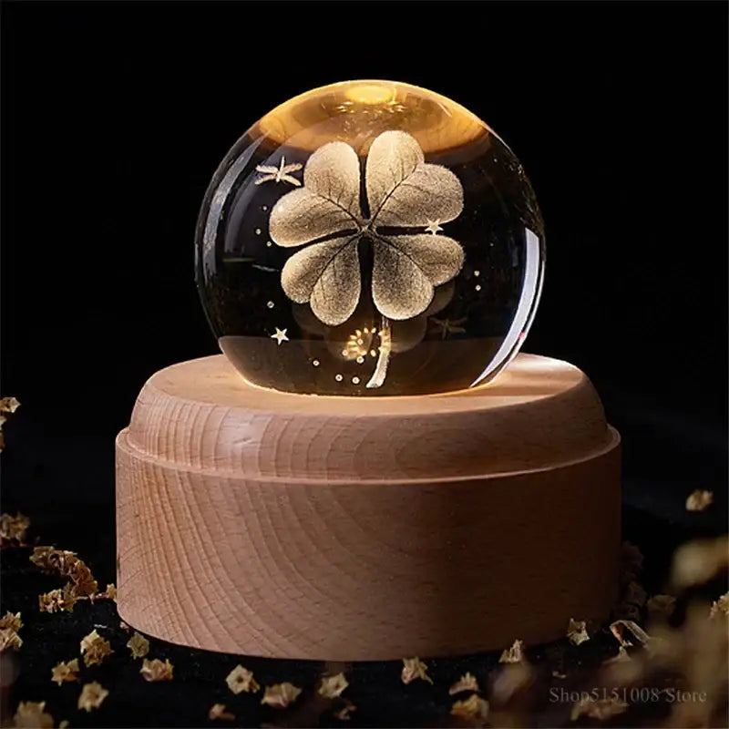 Glowing glass crystal ball night light with golden four-leaf clover on light wooden base for bedroom decorbites crystal ball