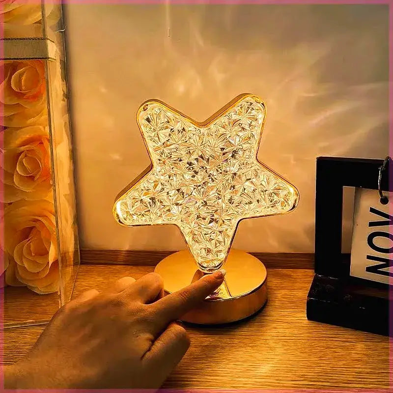 A golden star-shaped led crystal night light with touch dimming feature emitting warm ambient bedside illumination