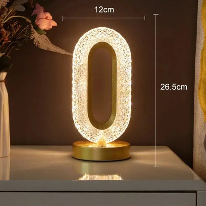 A glowing oval-shaped led lamp with a gold base and crystal mesh design featuring touch dimming night light function