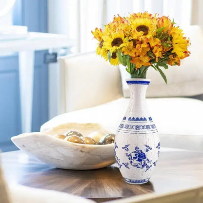 A white ceramic 3d puzzle vase with blue floral and geometric patterns featuring a crackled glaze finish building set