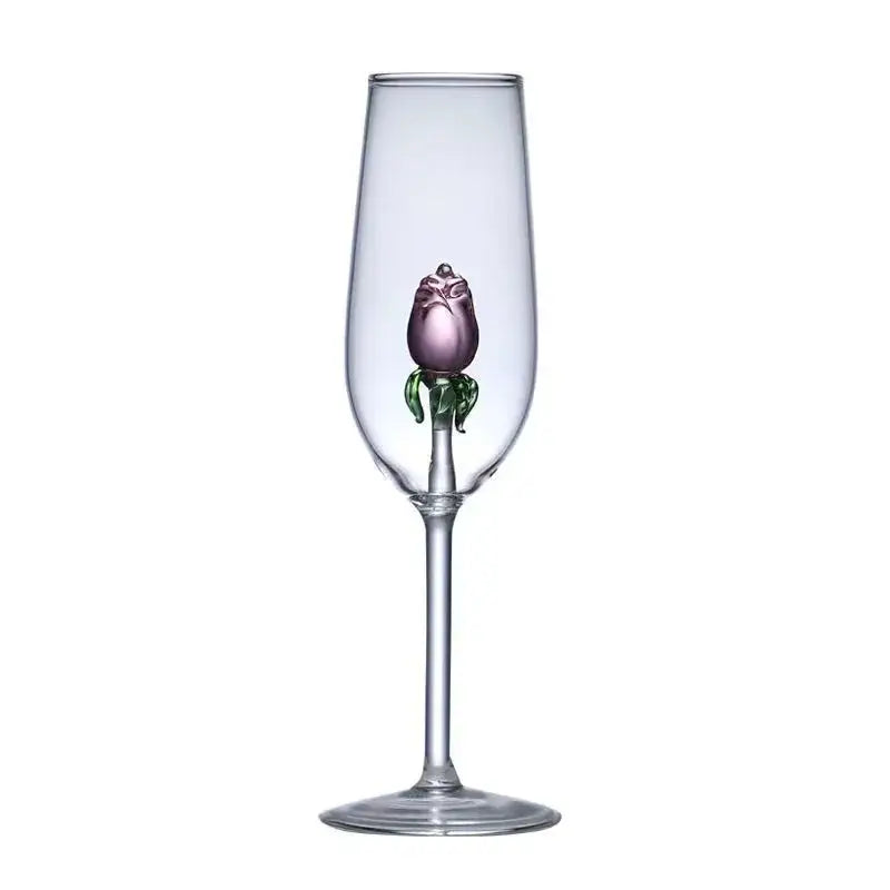 A clear glass rose champagne flute with a hand-blown purple rose and green leaves in the stem decorbites 3d rose