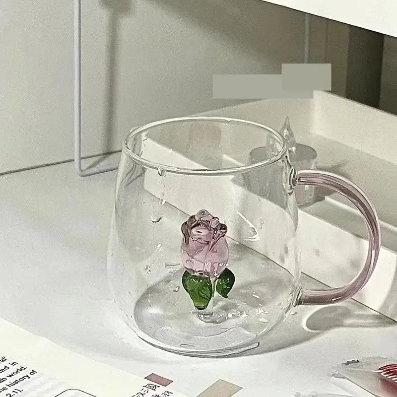 Clear glass rose champagne flute with delicate pink 3d rose and green leaves embedded in the base by decorbites