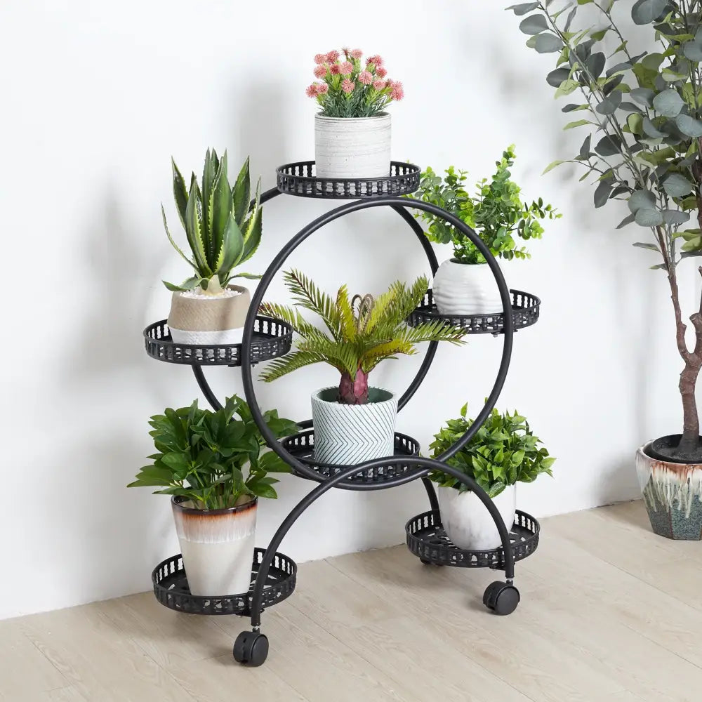Black circular metal plant stand with wheels and perforated stand shelves for holding 6 pots by DecorBites™