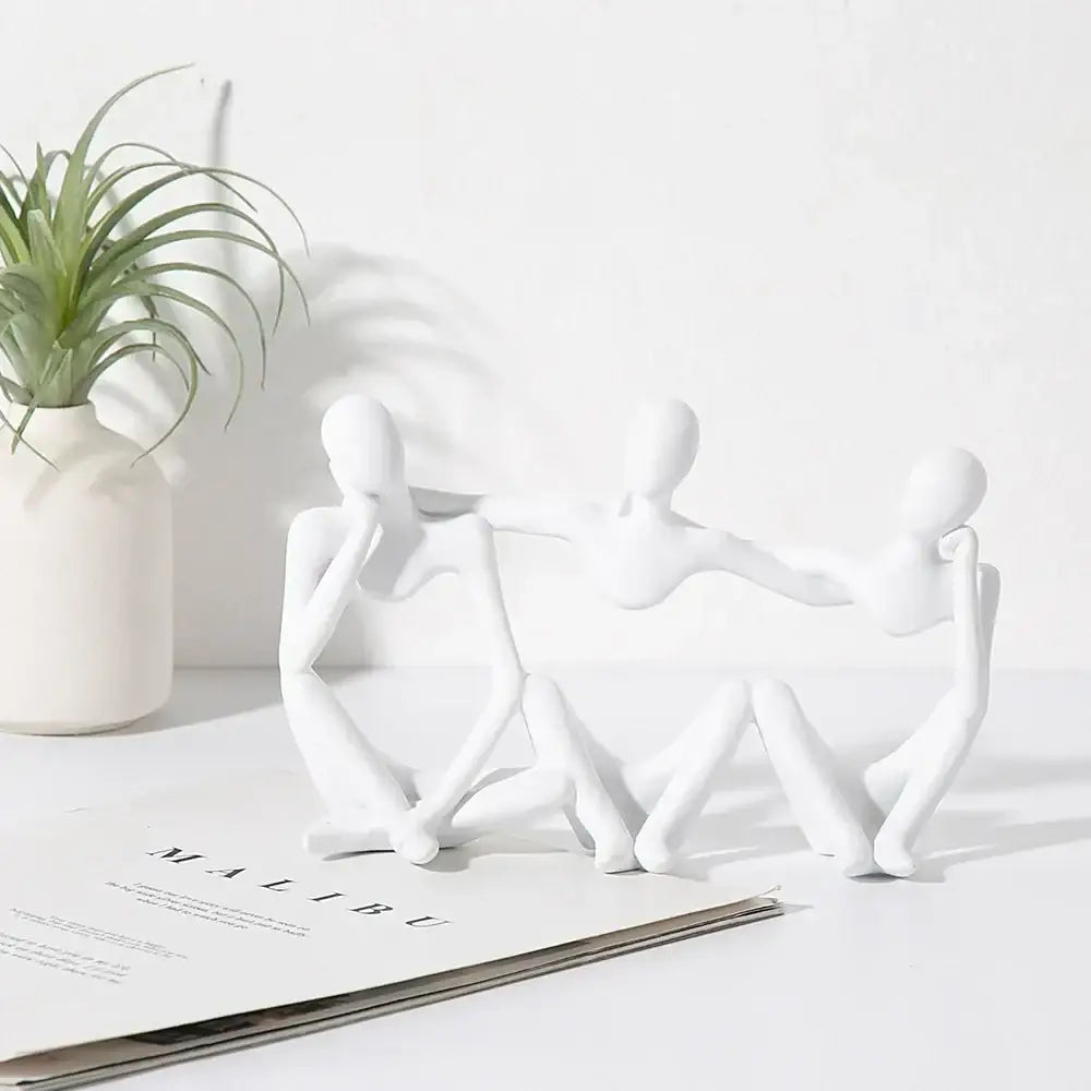 White ceramic abstract friendship figurine with three connected seated figures for living room decor