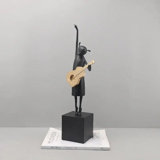 Abstract black and gold guitarist resin sculpture featuring a stylized girl figurine on a black cube base for decor