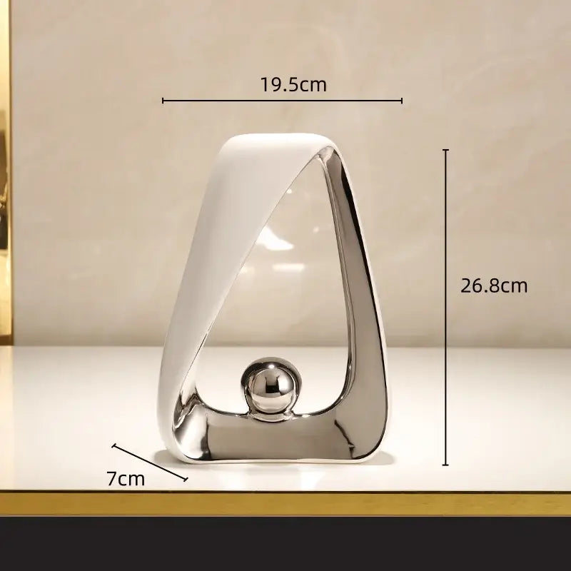 Modern abstract geometric triangles sculpture with polished silver frame white ceramic base and reflective golden ball for home decor