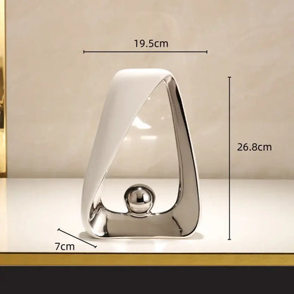 Modern abstract geometric triangles sculpture with polished silver frame white ceramic base and reflective golden ball for home decor