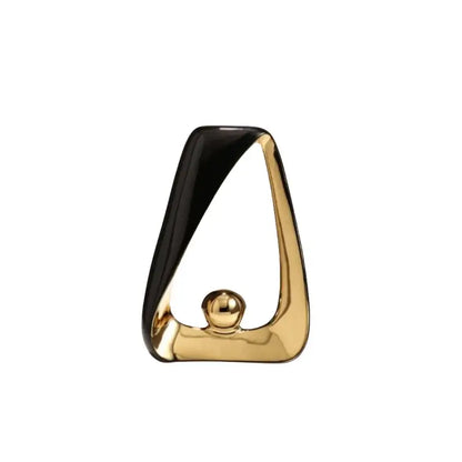 A sleek black and gold geometric triangles sculpture featuring a golden ball for modern home decor