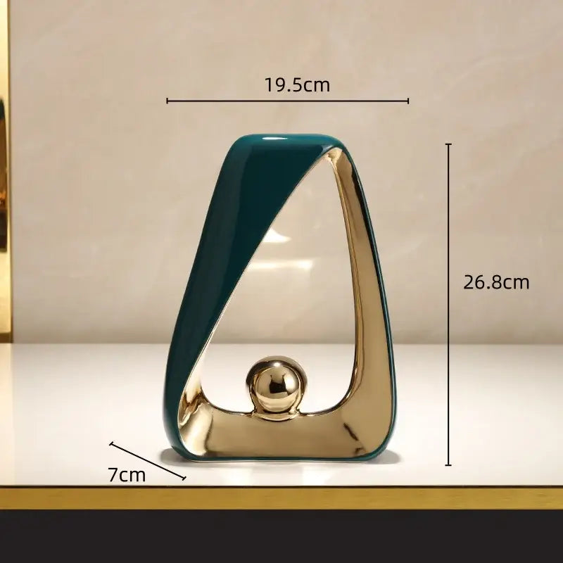 A sleek ceramic geometric triangles sculpture with a golden ball and glossy teal finish for modern home decor