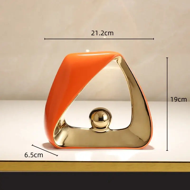 Abstract orange and gold ceramic geometric triangles sculpture with a polished golden ball for home decor