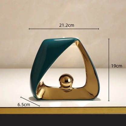 Modern teal and gold ceramic geometric triangles sculpture with a golden ball for stylish home decor living room display