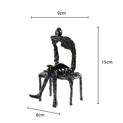 Black textured metal handicraft figure of a gymnast seated on an abstract chair for living room decorbites gymnast metal