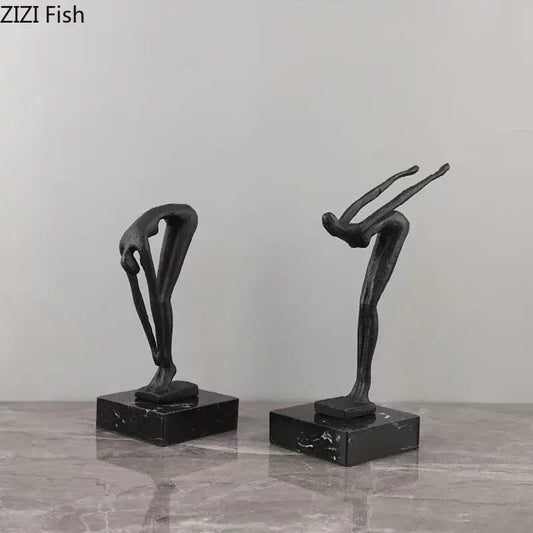 Two sleek black metal abstract gymnast statue desk ornaments on polished dark marble bases for decorbites decorbites gymnast statue