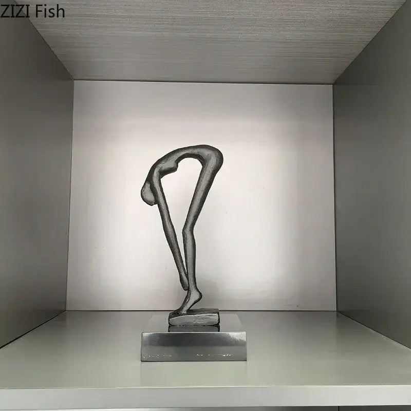 A sleek minimalist black metal gymnast statue desk ornament in an elegant bending pose for decorbites gymnast statue decor