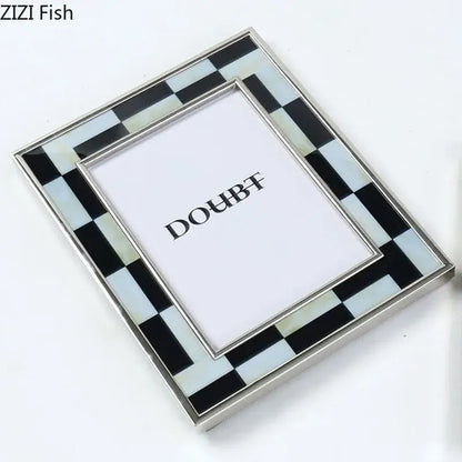 A sleek black and white plaid photo frame with mother-of-pearl inlays and polished silver edges for desktop decorbites decor