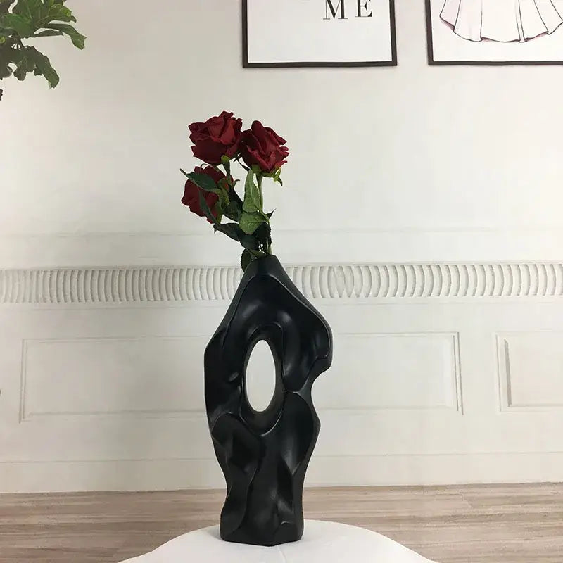 Black abstract ceramic vase with central oval opening and deep red roses for living room decor by decorbites black white abstract ceramic
