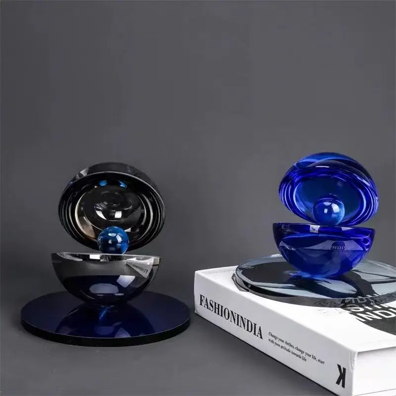 A sleek glossy blue glass semi-circle ornament with mirrored interior and reflective base for home decor by decorbites crystal glass