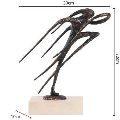 Bronze-colored geometric abstract face sculpture with elongated limbs on beige base for living room decor