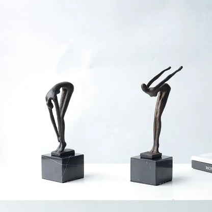 Two abstract bronze diving sportsman metal sculptures on black marble bases for living room decor