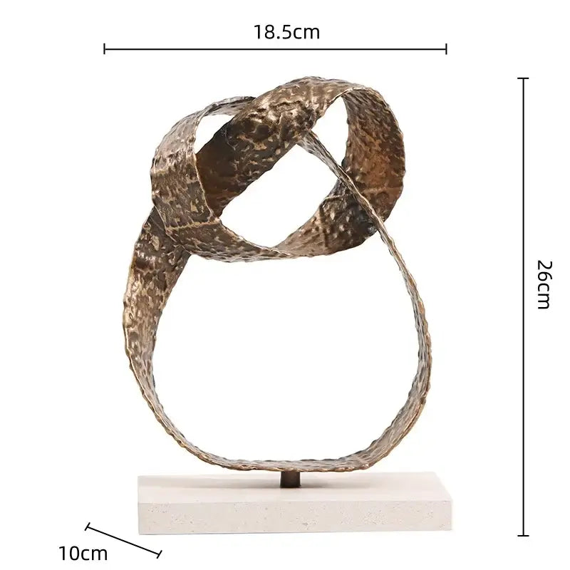 Bronze textured metal abstract geometric sphere pendant sculpture with intertwined loops on white stone base for decor
