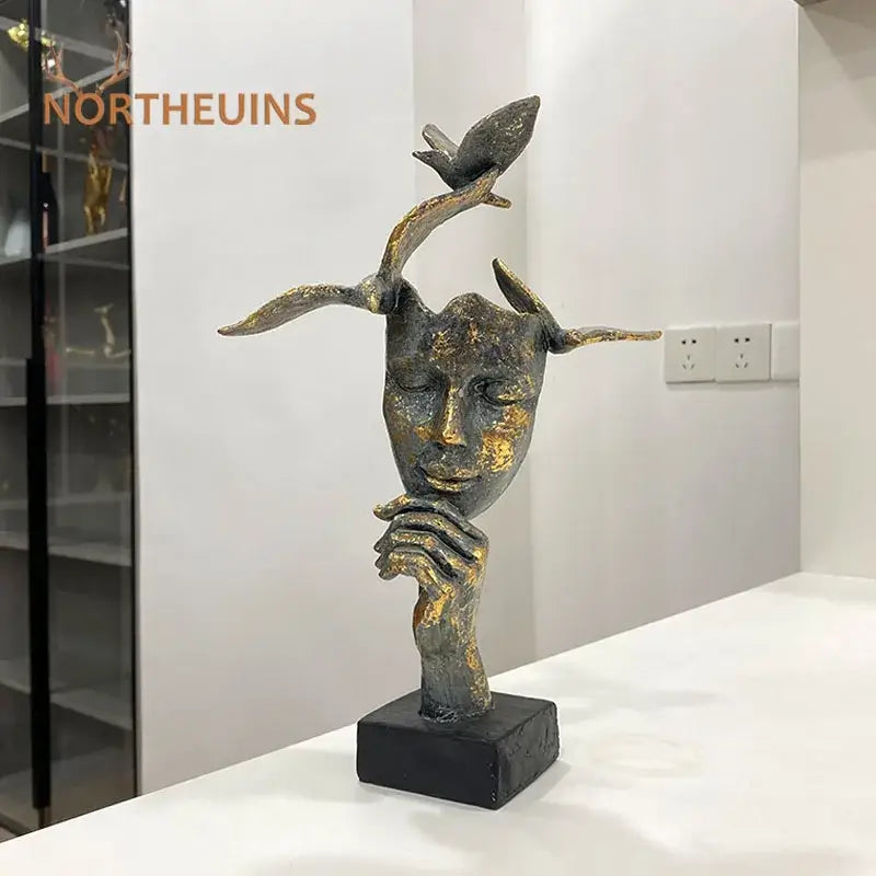 Bronze and gold toned abstract bird figurine statue with golden mask bird design on black base for office decor
