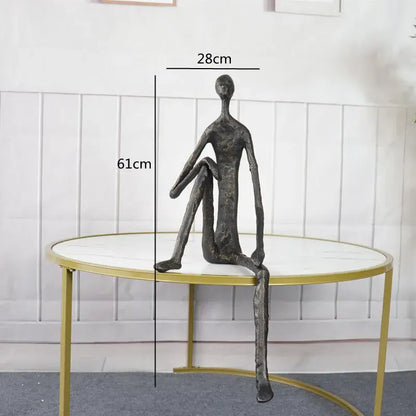 A sleek dark bronze abstract metal human sculpture with elongated limbs ideal for living room decorbites decor