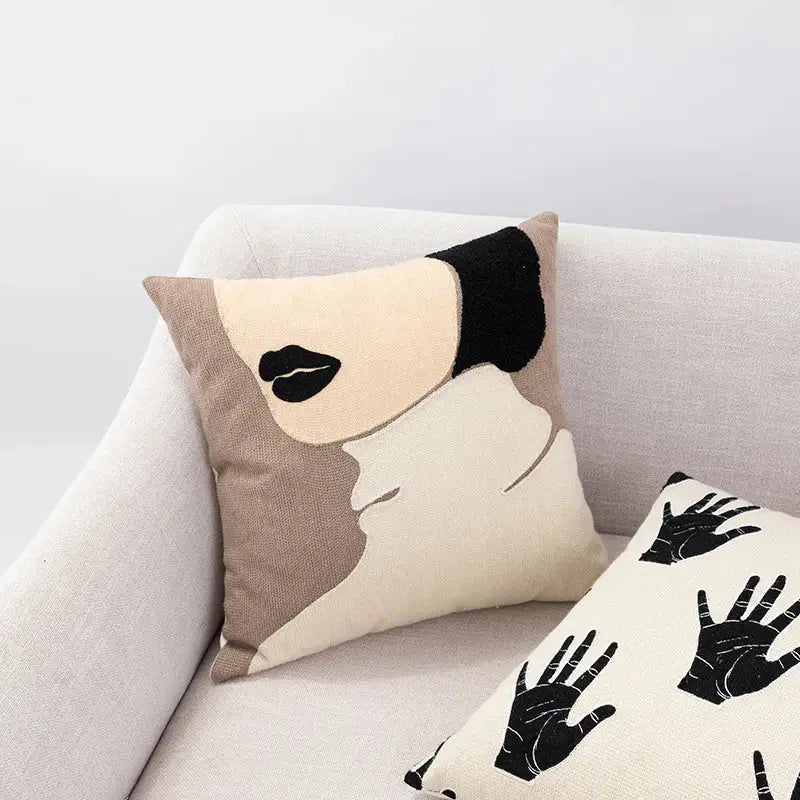 Beige and black embroidered cushion cover with stylized face design featuring bold lips and short hair decorbites abstract handmade