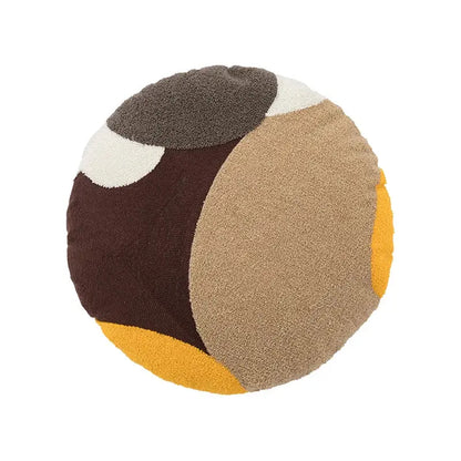 Round plush cushion cover with bold geometric patches in brown, beige, mustard yellow, and cream for living room decorbites abstract handmade knot decor