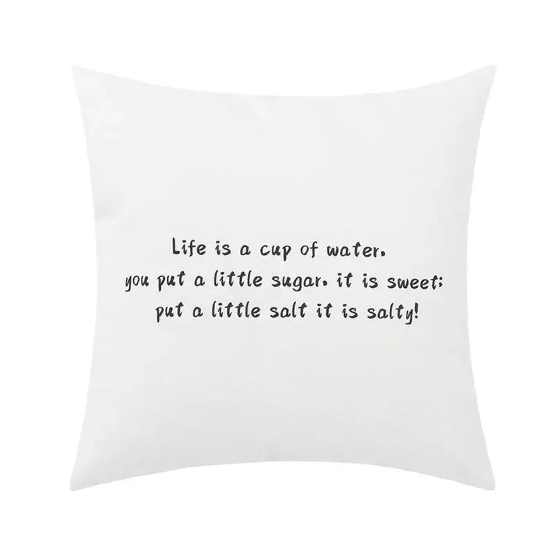 White square pillow cover with black abstract geometric print and life is a cup of water text for decorbites living room decor