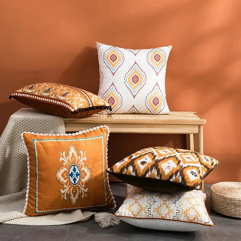 Orange velvet throw pillow with embroidered floral design and white pom-pom trim for decorbites abstract geometric cushion cover