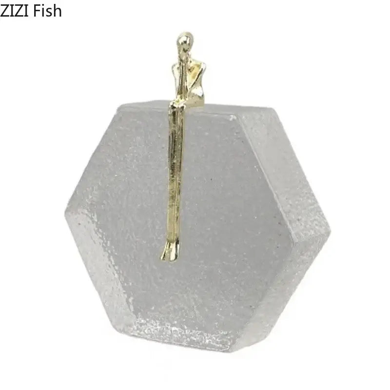 A delicate gold-toned abstract figures desk sculpture on a hexagonal decorbites crystal base for living room decor