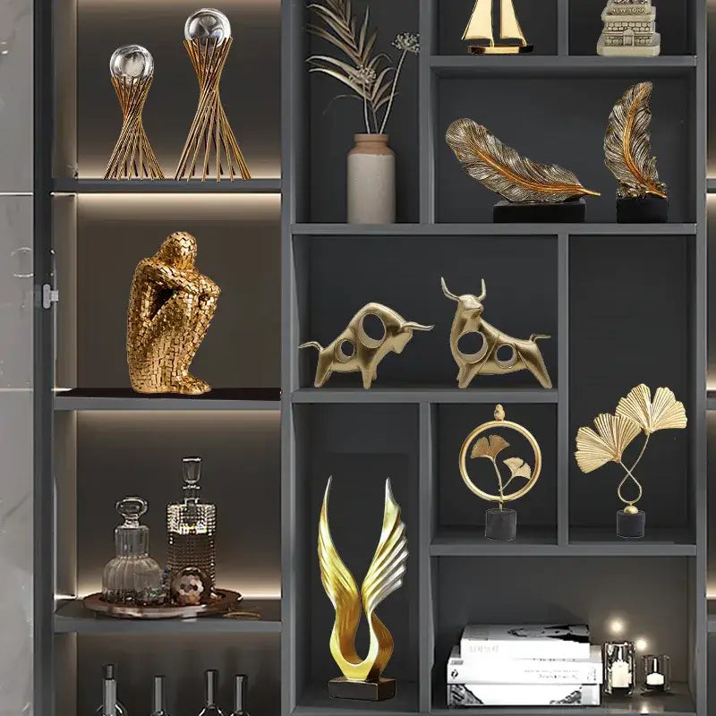 Gold resin statue of an abstract bull with cut-out circular details and polished metallic finish for living room decor
