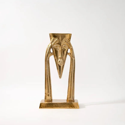 Golden metallic abstract golden masked figure sculpture with elongated features and slender arms for living room decor