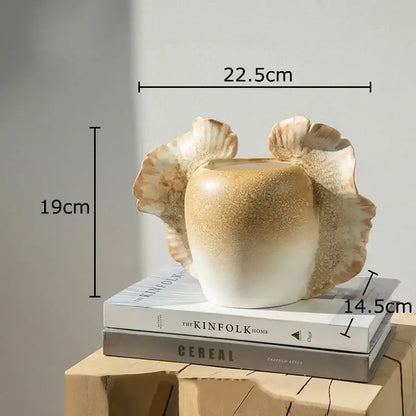 Creamy beige ceramic butterfly wings vase with fluted leaf handles and textured glaze for bedroom decor
