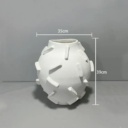 White ceramic geometric block vase with rounded body and rectangular tabs for decorbites geometric block living room decor