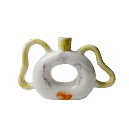 White ceramic abstract handle vase with yellow purple orange glaze accents for green and red living room decorbites decor