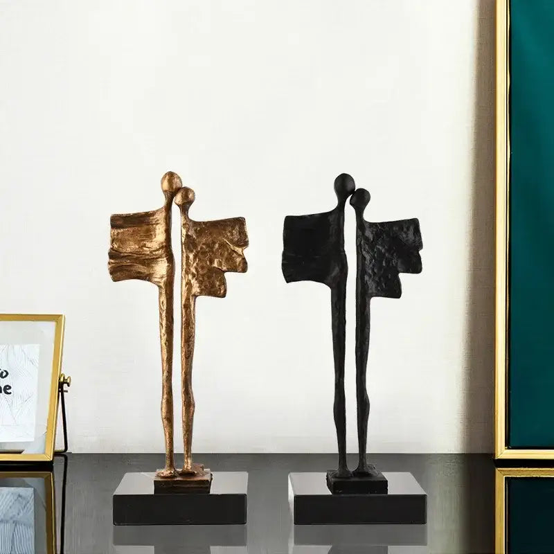 Abstract iron cast couple statue featuring textured gold and matte black figurines with elongated limbs for living room decorbites decor