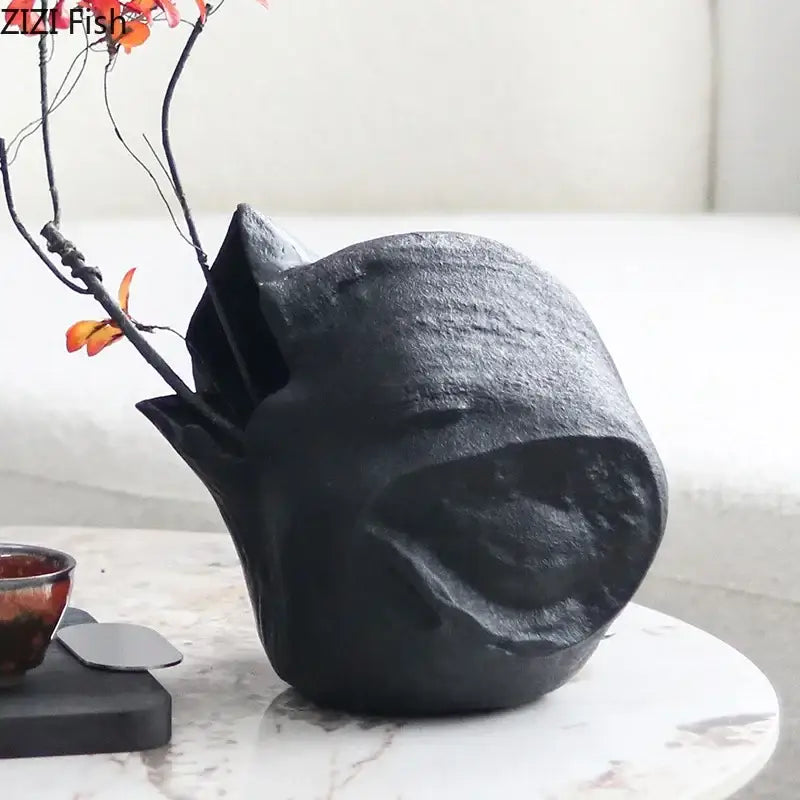 Matte black sculpted ceramic vase with rough texture and abstract artwork ideal for living room decorbites black vase