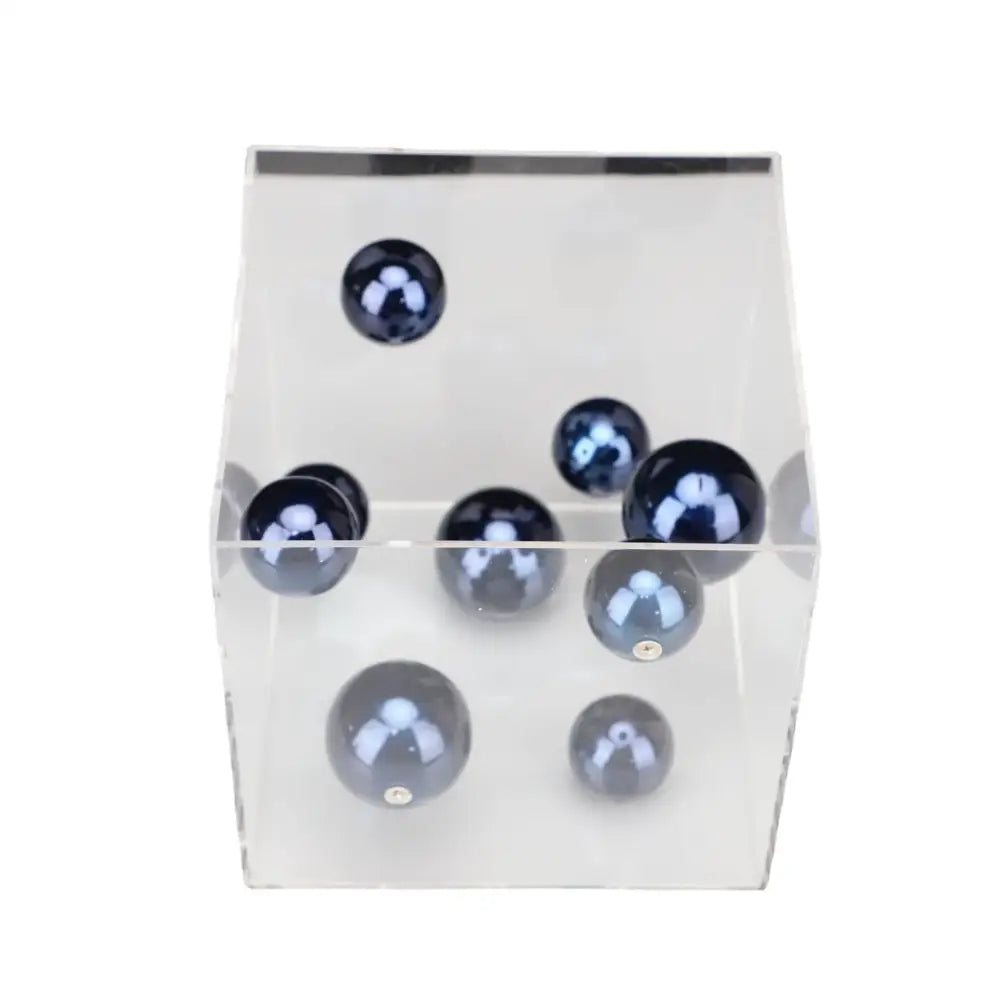 Clear acrylic cube display case holding glossy dark blue spheres as abstract metal ball artworks for living room decorbites decor