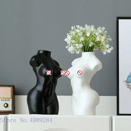 Abstract nude female black and white ceramic torso vases with one holding white flowers for living room decor