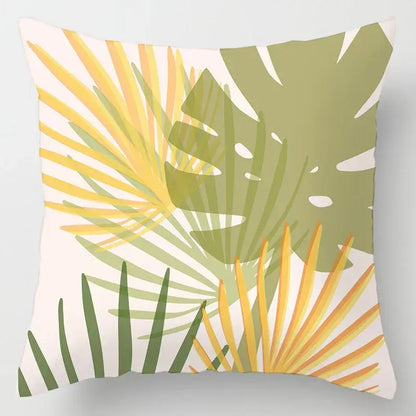 Square cushion cover with vibrant geometric leaves print in yellow green and olive on off-white for living room decor