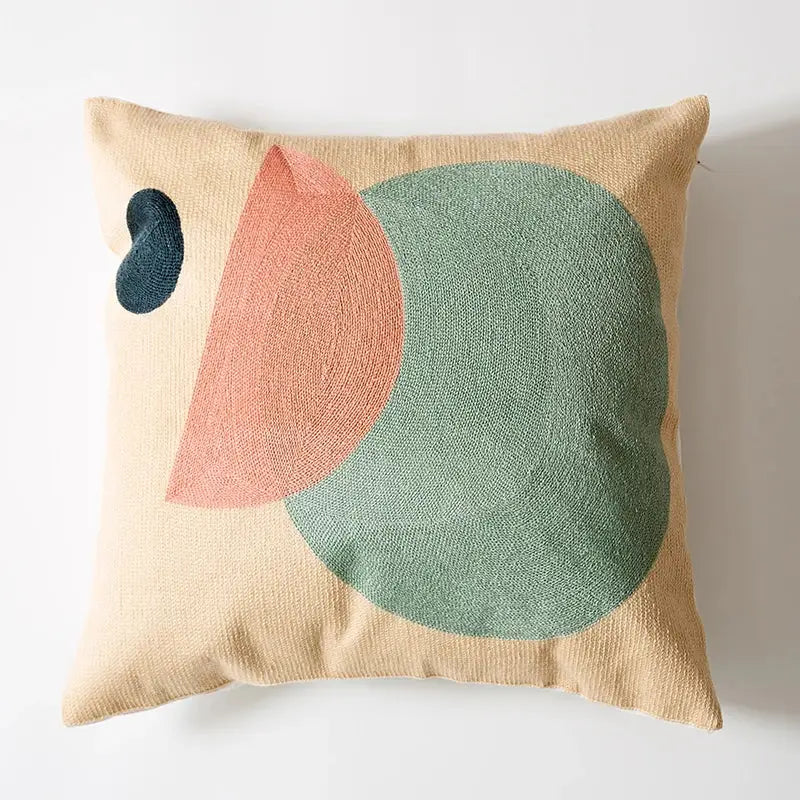 Beige cushion cover with embroidered abstract teal circle peach semicircle and dark blue teardrop decorbites geometric cushion