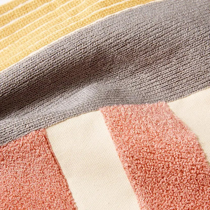 Abstract pastel geometric cushion cover with a soft textured towel fabric in mustard yellow gray cream and dusty rose colors