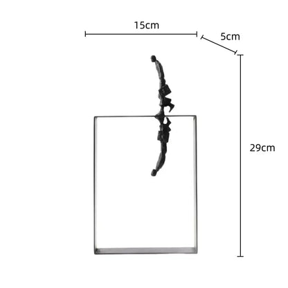 Black metal figurine balancing on edge of transparent glass block resin sculpture decorbites abstract resin sculpture decor