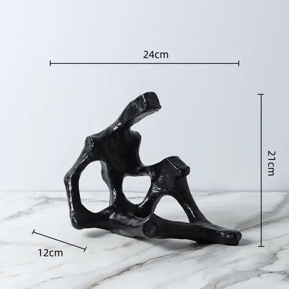 Black abstract skeleton decor figure sculpture with branching glossy finish used as living room bookends