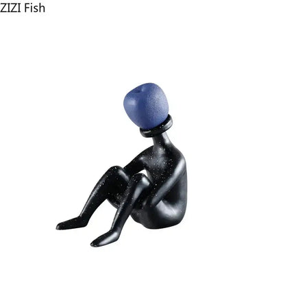 Black resin abstract thinker figurine with blue textured spherical head and speckled surface for living room decor