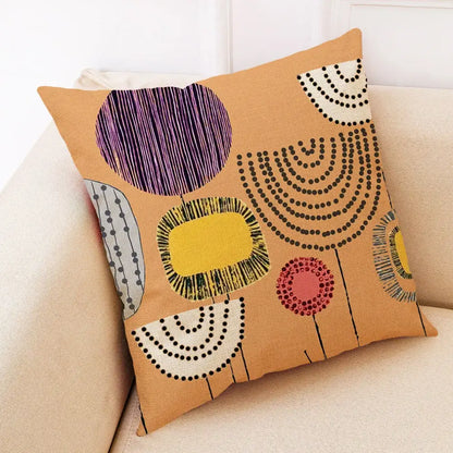 Tan linen pillow cover with abstract tree flower embroidered geometric patterns in purple yellow black white and pink