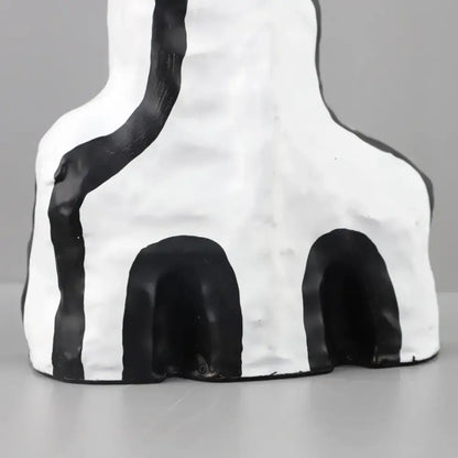 Abstract white ceramic figurine vase with black geometric eye pattern stripes and two arched openings for living room decor