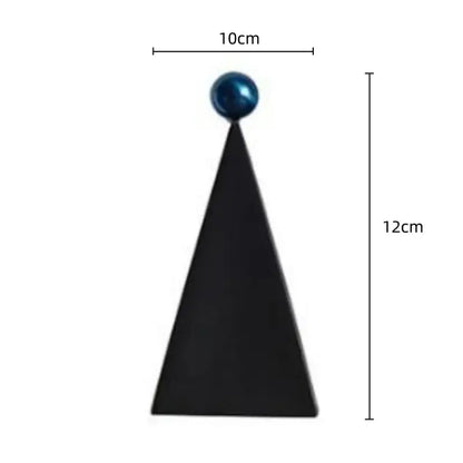 Black triangular sculpture with glossy blue sphere at apex geometric triangle blue decorbites geometric triangle living room decor