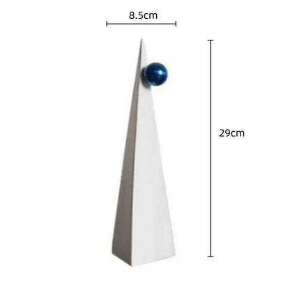 A sleek white ceramic geometric triangle ornament with a glossy blue sphere for living room decorbites decor